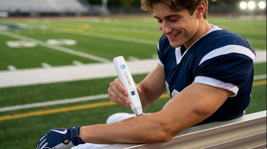 Football player using LaserTouchOne device on forearm
